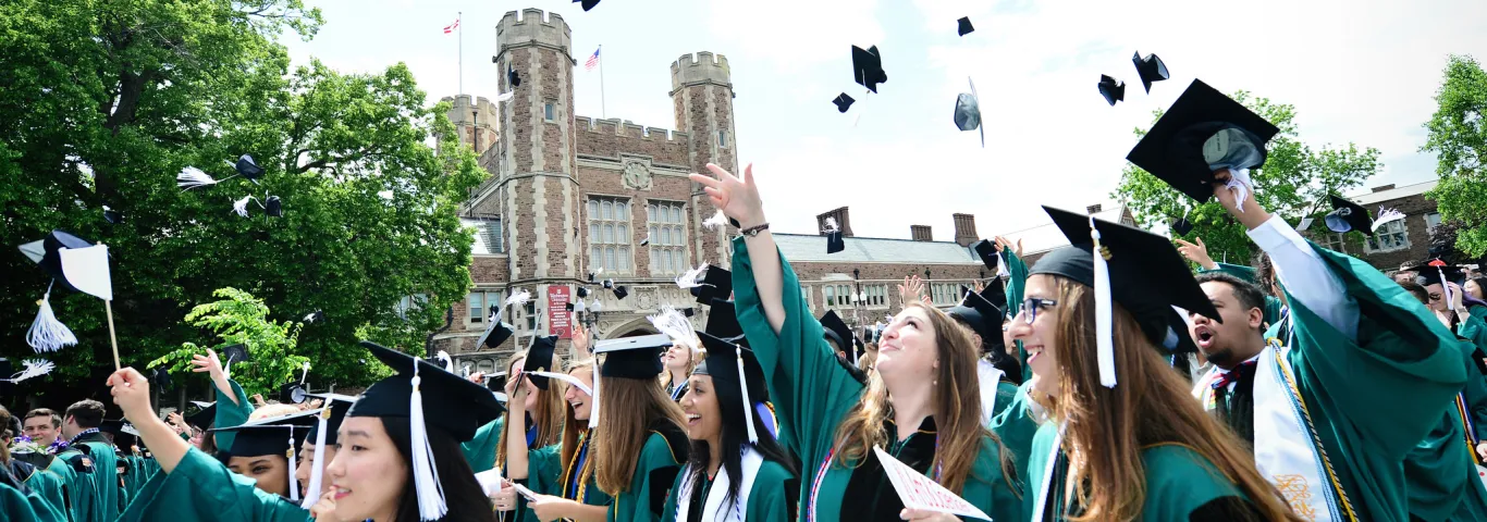 students throwing graduation caps