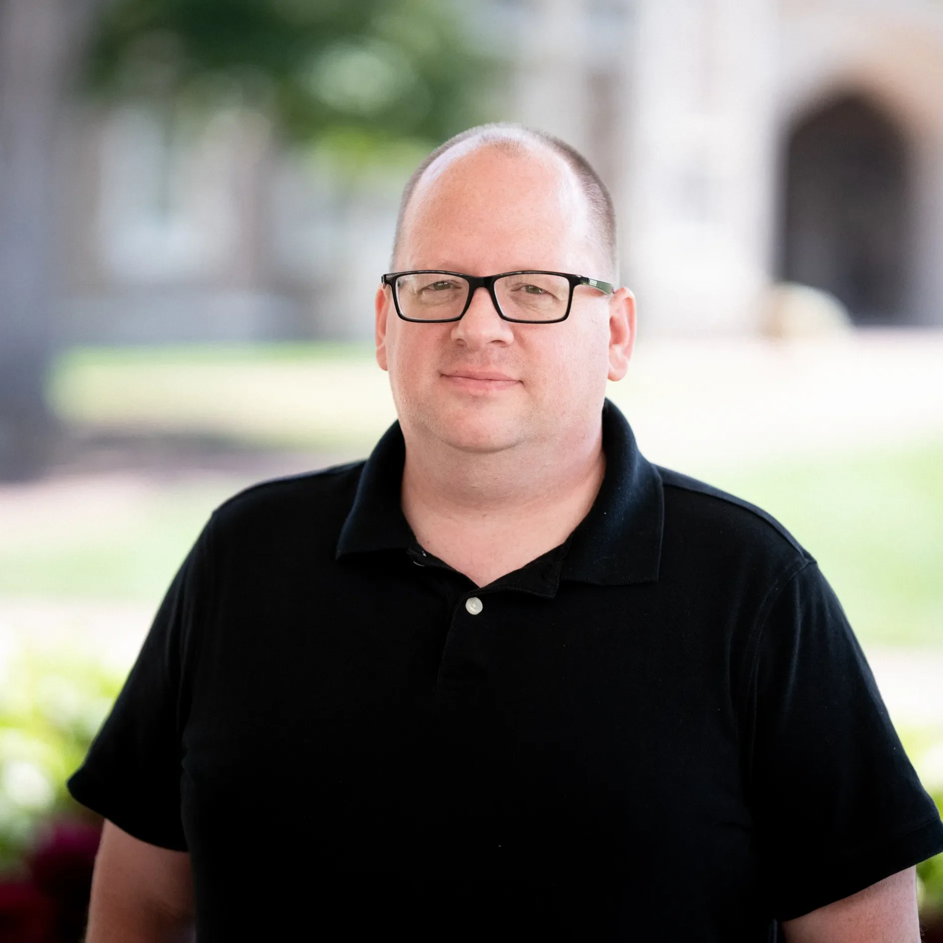 Dowell looking at the camera with a campus background