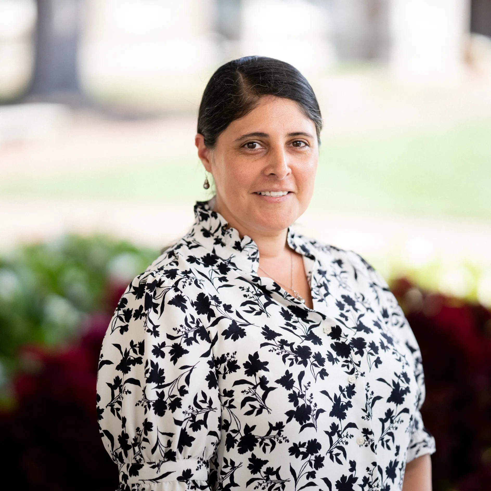 Ledesma Ortiz smiling to the camera with a campus background
